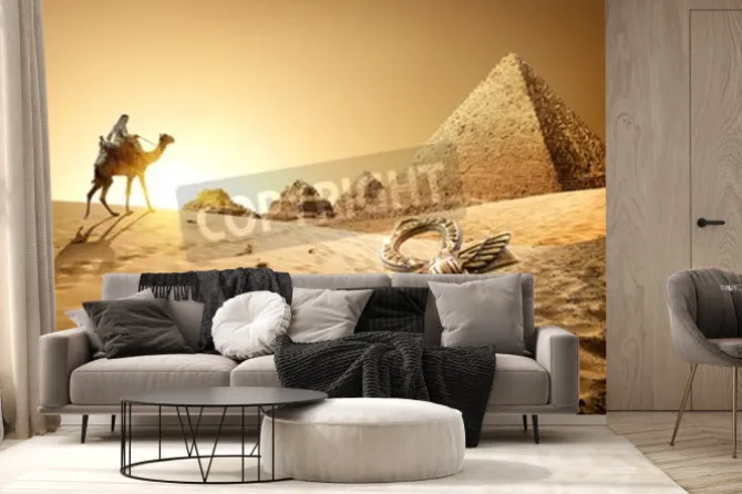 Fototapeta: Beduin na wielbłądzie niedaleko piramid i ankh w pustyni