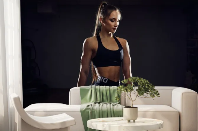 Fototapeta: Fitness and sport concept. brutal athletic woman pumping up muscules