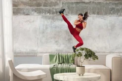 Fototapeta: Fitness girl kicking. full-length portrait of sporty woman with