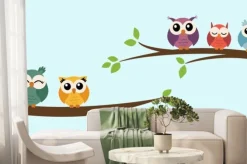 Fototapeta: Five cute colorful vector owls are sitting on a tree branch.