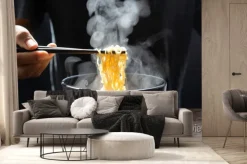 Fototapeta: Hand uses chopsticks to pickup tasty noodles with steam and smoke
