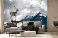 Fototapeta: Jeleń stojący na skale na tle chmur
