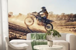 Fototapeta: Motocyklista jadący po wzgórzu