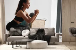 Fototapeta: Photo of slim fitness model in black sportswear isolated on white