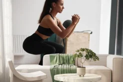 Fototapeta: Photo of slim fitness model in black sportswear isolated on white