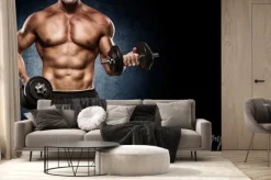 Fototapeta: Przystojny mężczyzna z dużymi mięśniami, stwarzających na aparat
