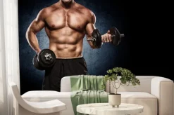 Fototapeta: Przystojny mężczyzna z dużymi mięśniami, stwarzających na aparat