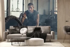 Fototapeta: Umięśniony mężczyzna ćwiczy z liną