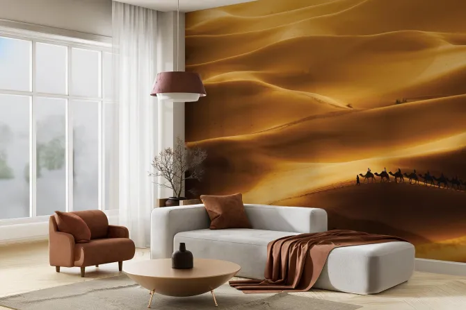 Fototapeta: Wielbłądy idące przez ogromną pustynię
