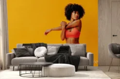 Fototapeta: Young fit black woman in sportswear posing isolated on yellow