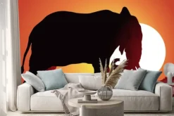 Naklejka: Czarna sylwetka słonia na tle słońca