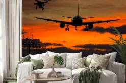 Naklejka: Dron i lądujący samolot o zachodzie słońca