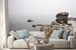 Naklejka: Fog above the water on a lake with large stones. clear water