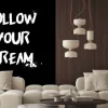 Naklejka: Follow your dream quotes tshirt design. brush stroke font style.