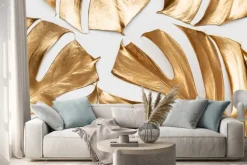 Naklejka: Golden monstera leaves on white background