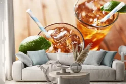 Naklejka: Iced sweet tea with lime wedges and retro paper straw shot from
