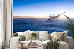 Naklejka: Komercyjne odrzutowy samolot lecący nad chmurami