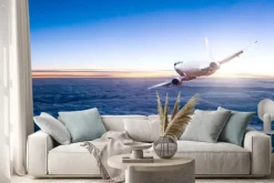 Naklejka: Komercyjne odrzutowy samolot lecący nad chmurami