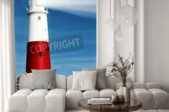 Naklejka: Latarnia morska na skałach z wiązek światła