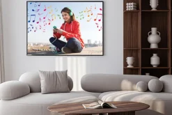 Plakat: Happy young woman with smartphone and headphones