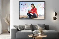 Plakat: Happy young woman with smartphone and headphones