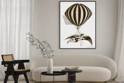 Plakat: Historic aerialist wearing wings while suspended from a balloon.