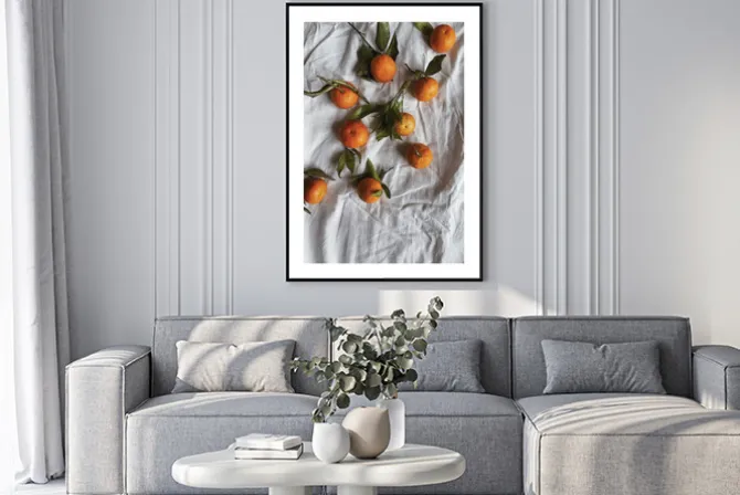 Plakat: Mandarynki z liśćmi na białym płóciennym obrusie