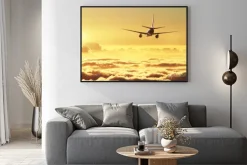 Plakat: Samolot na niebie o zachodzie słońca