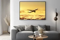 Plakat: Samolot na niebie o zachodzie słońca