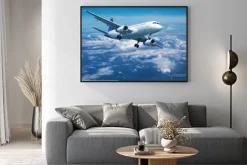 Plakat: Samolot pasażerski ponad chmurami