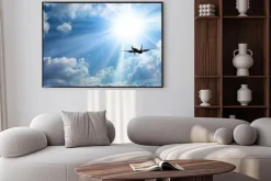 Plakat: Samolot pasażerski na tle nieba i słońca