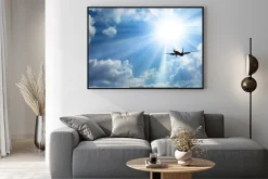 Plakat: Samolot pasażerski na tle nieba i słońca