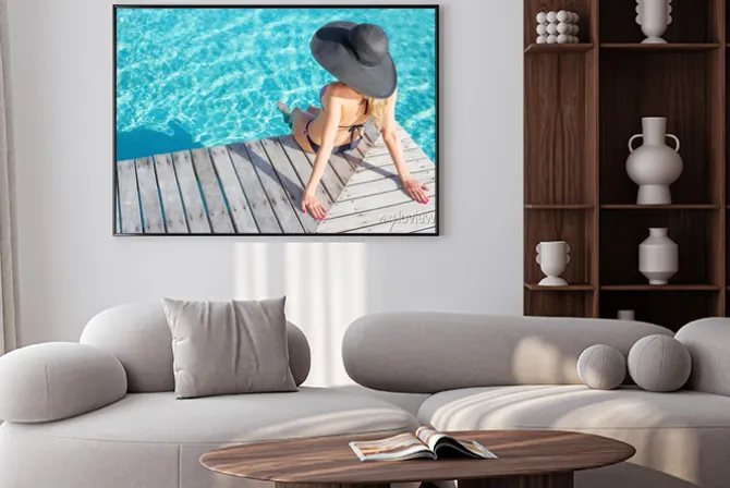 Plakat: Woman sitting on the deck by the pool